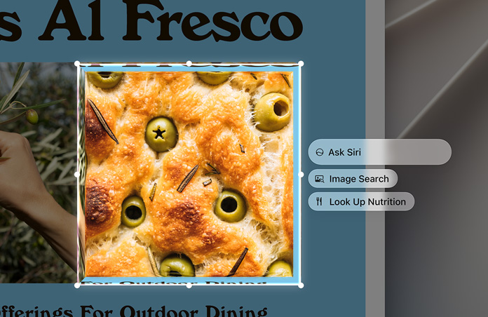 Egy olívás focaccia kijelölt képe mellett az „Ask Siri” (Kérje meg Sirit), az „Image Search” (Képkeresés) és a „Look Up Nutrition” (Tápanyagok definiálása) lehetőségek szerepelnek
