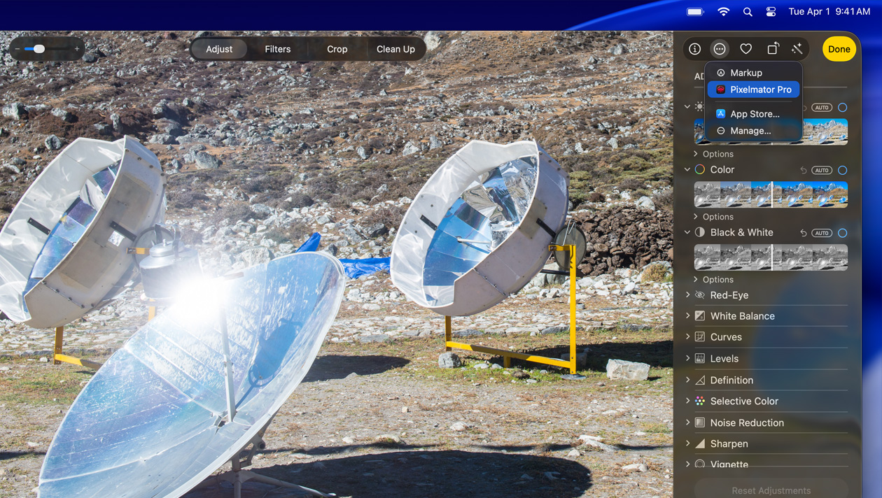 MacBook Pro 16 screen, photo of three silver space telescopes on ground, image editing tools