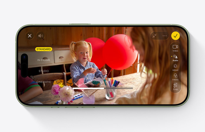 iPhone 17, front exterior, video with Audio Mix feature in use, child playing at a table with balloons
