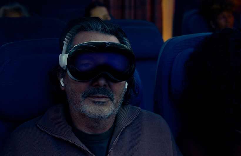 Person seated on an airplane wearing Apple Vision Pro assembled with Dual Knit Band