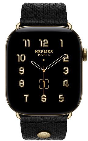 Apple Watch Hermès Series 12, หน้าปัดนาฬิกาอนาล็อก Clou de Selle (เข็มชั่วโมง เข็มนาที และเข็มวินาที, กลไกหน้าปัด: ข้างขึ้นข้างแรม, วันที่), ตัวเรือนไทเทเนียม, สีเรเดียนท์โกลด์, ภายนอกด้านขวา, Digital Crown, ปุ่มด้านข้าง, จับคู่กับสายแบบ Clou de Selle Satin สี Noir, สายเว็บบิ้งซาตินสีดำเรียบเนียน พร้อมฮาร์ดแวร์สีเรเดียนท์โกลด์ที่เข้ากับตัวเรือนนาฬิกา