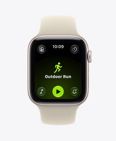 Apple Watch SE 3, aluminum case, starlight colour, screen shows Workout app (outdoor run), right side exterior, Digital Crown dial, Sport Band, sand colour (pale tan)