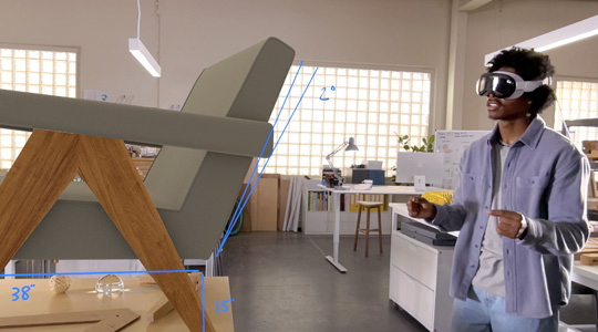 Apple Vision Proを装着したデザイナーが、ピンチのジェスチャーで椅子の3Dプロジェクションを回転させ、サイズを測定している