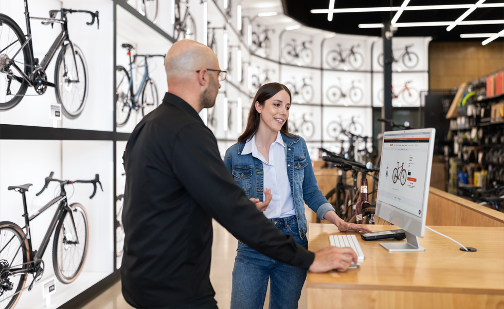 Julien Sicuro, Store Manager, walks a customer through bike selection using the crystal-clear Retina display on iMac.