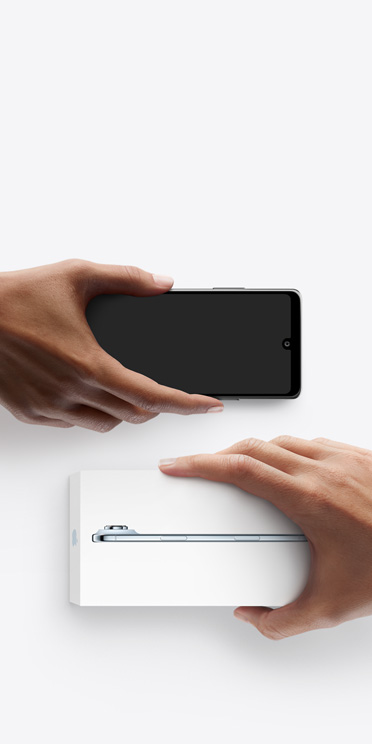 Hands exchanging phones, Android on the left without a box, on the right is a new iPhone Air in box