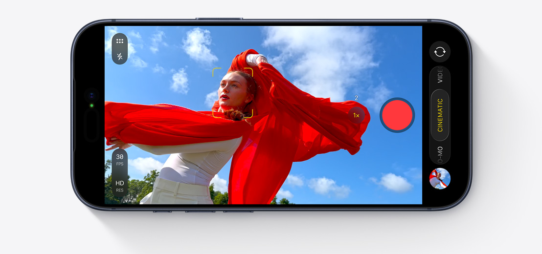 iPhone screen showing Cinematic Mode capturing person dancing outside with flowing red scarf