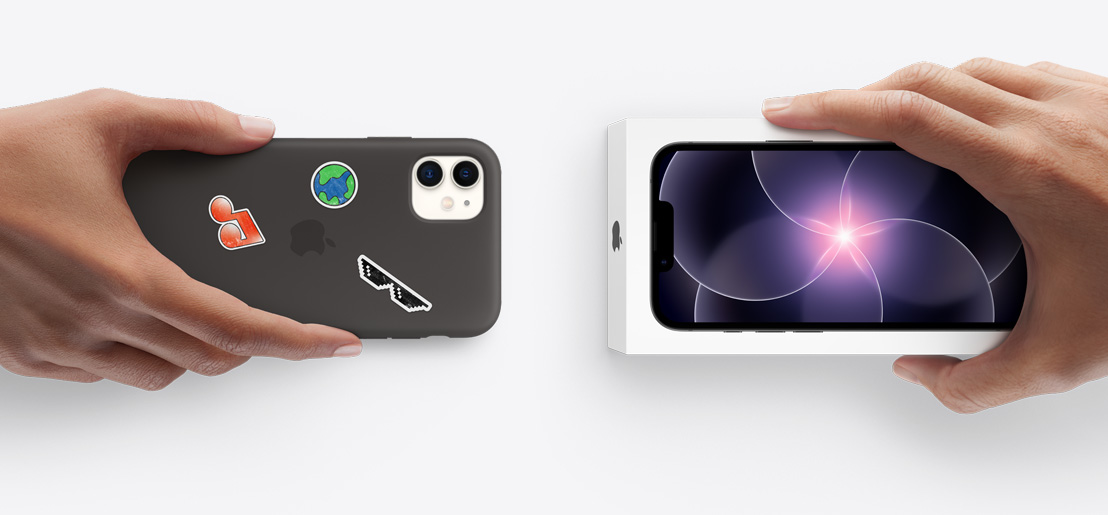 Two hands exchanging a trade-in, one hand holds an iPhone 11, the other hand holds an iPhone 17e box.